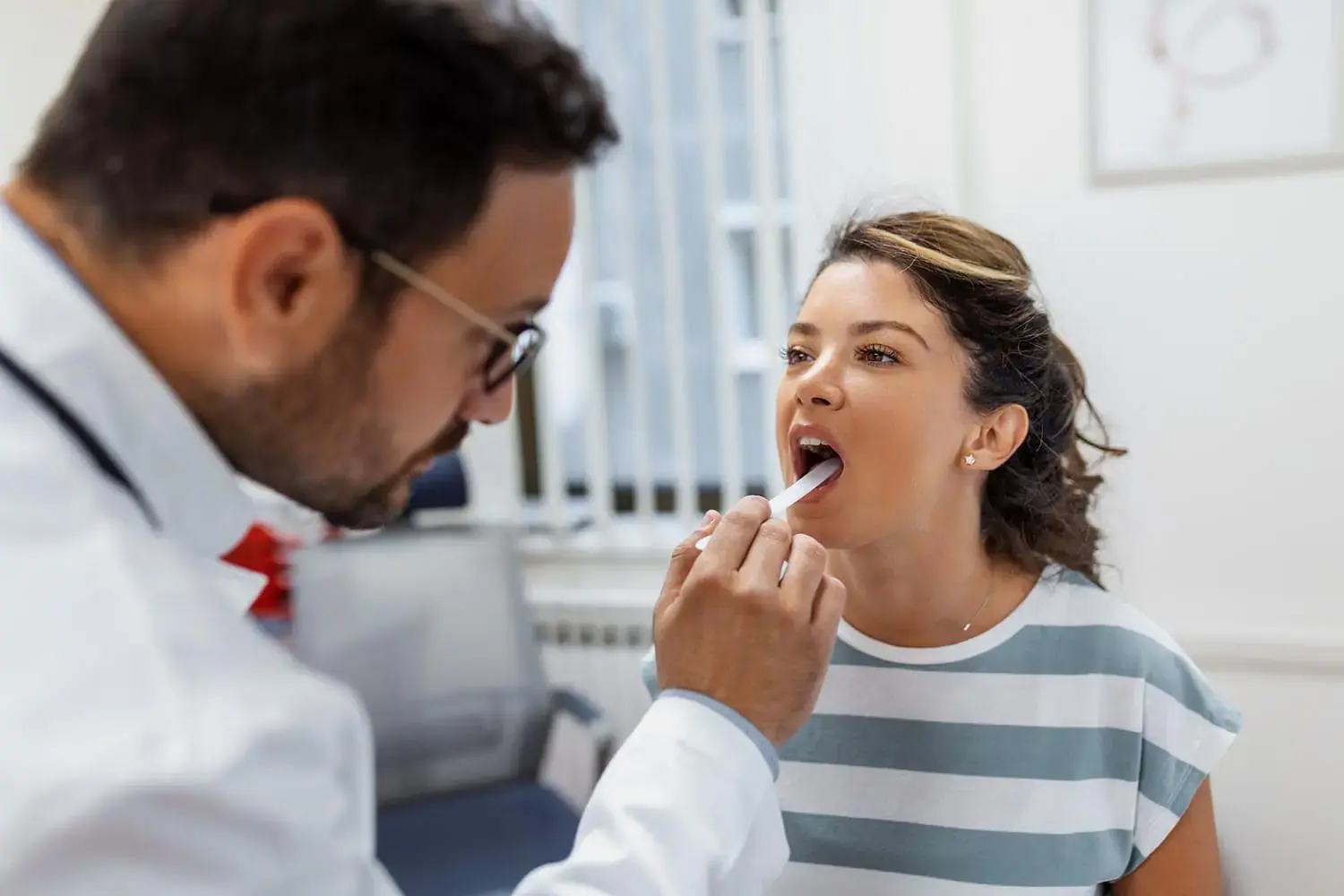 During a checkup at Natalie Yang Orthodontics Orthodontics in Vacaville, CA, a doctor checks for tongue thrust with a depressor. During a checkup at Natalie Yang Orthodontics Orthodontics in Vacaville, CA, a doctor checks for tongue thrust with a depressor.