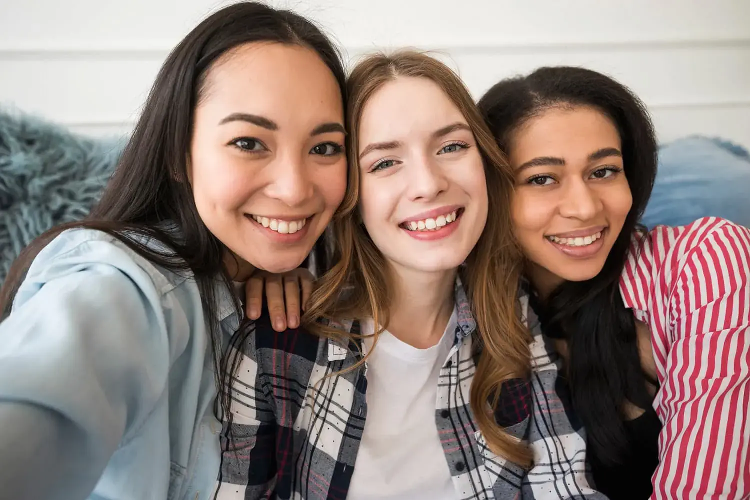 Smiling for a selfie indoors, three young women gather after discussing tongue thrust at Natalie Yang Orthodontics in Vacaville, CA. Smiling for a selfie indoors, three young women gather after discussing tongue thrust at Natalie Yang Orthodontics in Vacaville, CA.