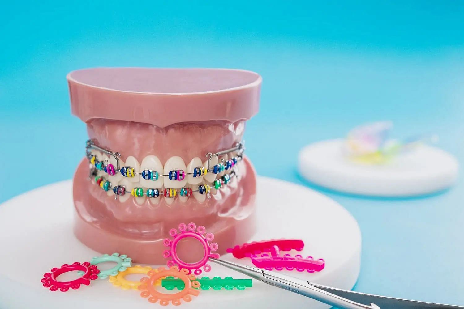 Colorful braces on a dental model metal braces with orthodontic tools, at Natalie Yang Orthodontics in Vacaville, CA.