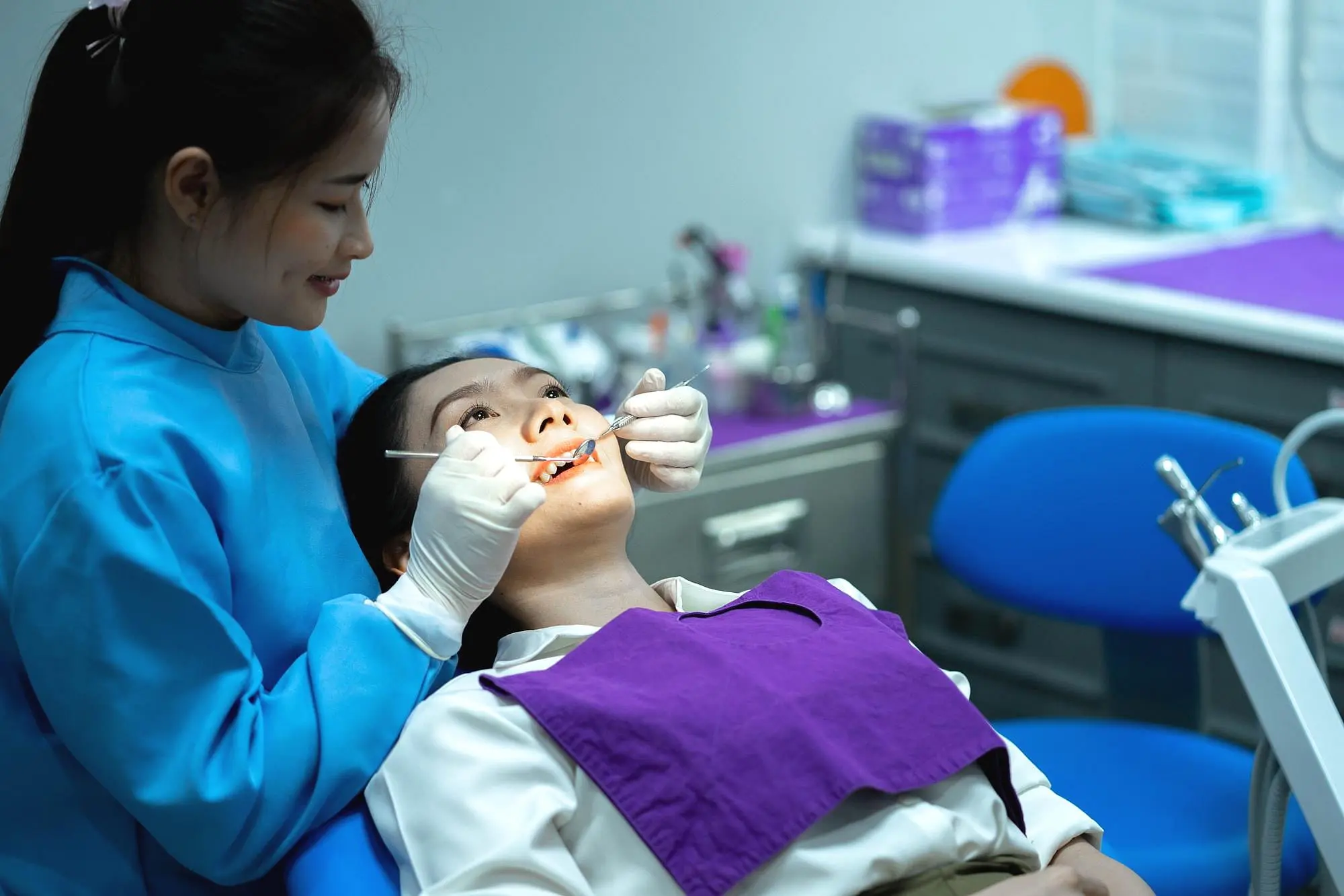 At Natalie Yang Orthodontics in Vacaville, CA, a dentist examines a patient’s teeth using dental instruments prepare for dental treatment with metal braces.