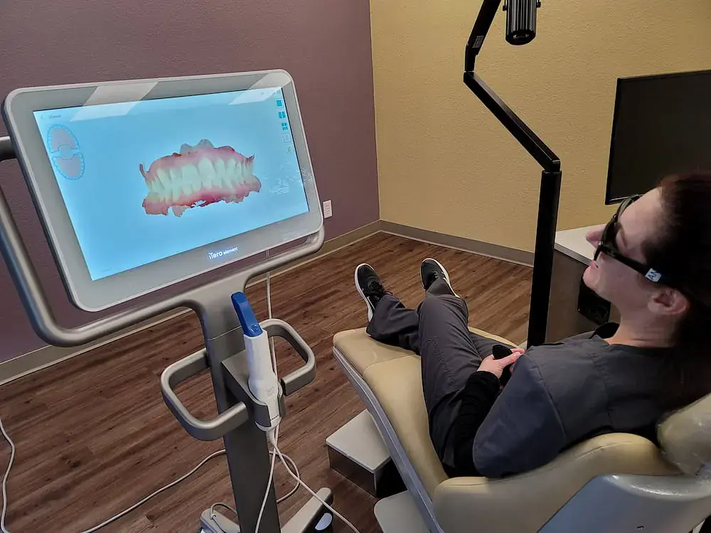 During a dental exam at Natalie Yang Orthodontics in Vacaville, CA, a patient views a 3D teeth model on screen, showcasing Orthodontic Appliances in use. During a dental exam at Natalie Yang Orthodontics in Vacaville, CA, a patient views a 3D teeth model on screen, showcasing Orthodontic Appliances in use.