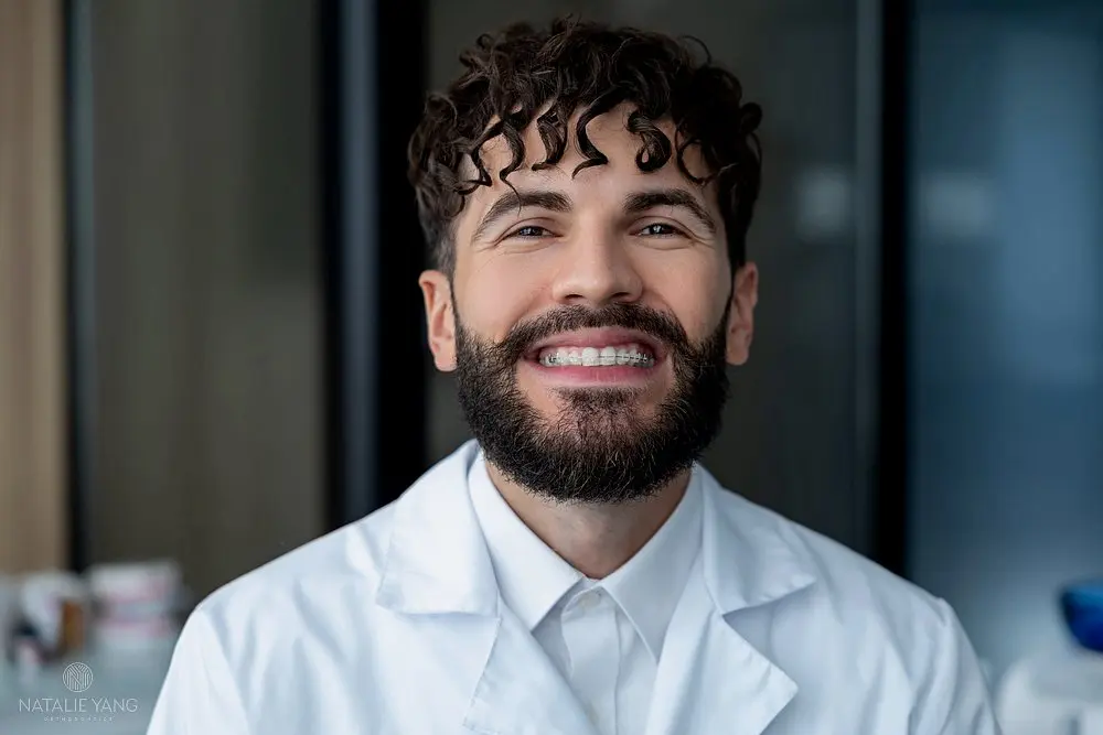 bearded man dentist clear braces showing importance dental care - Clear Braces vs Metal Braces in Vacaville, CA